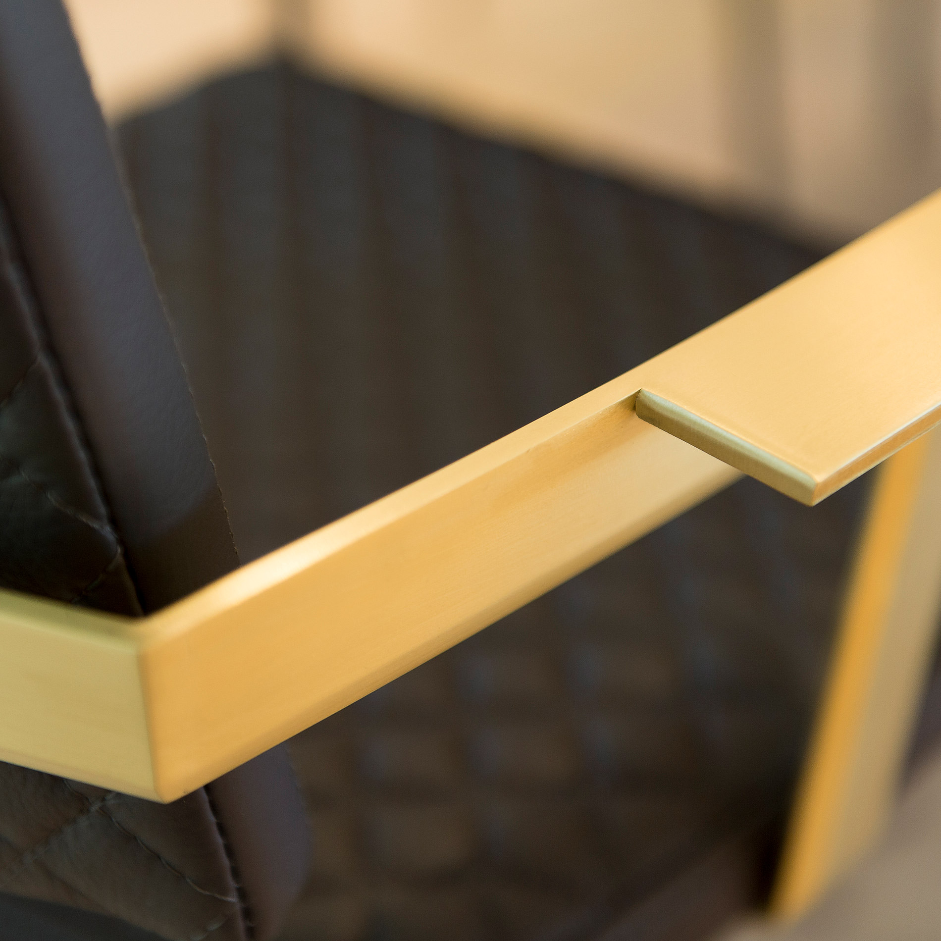 Although strong and solid the brass armrest of Australian designer FrancoCrea's luxury dining chairs are easy to rest on and comfortable for long chats sitting in the dining room