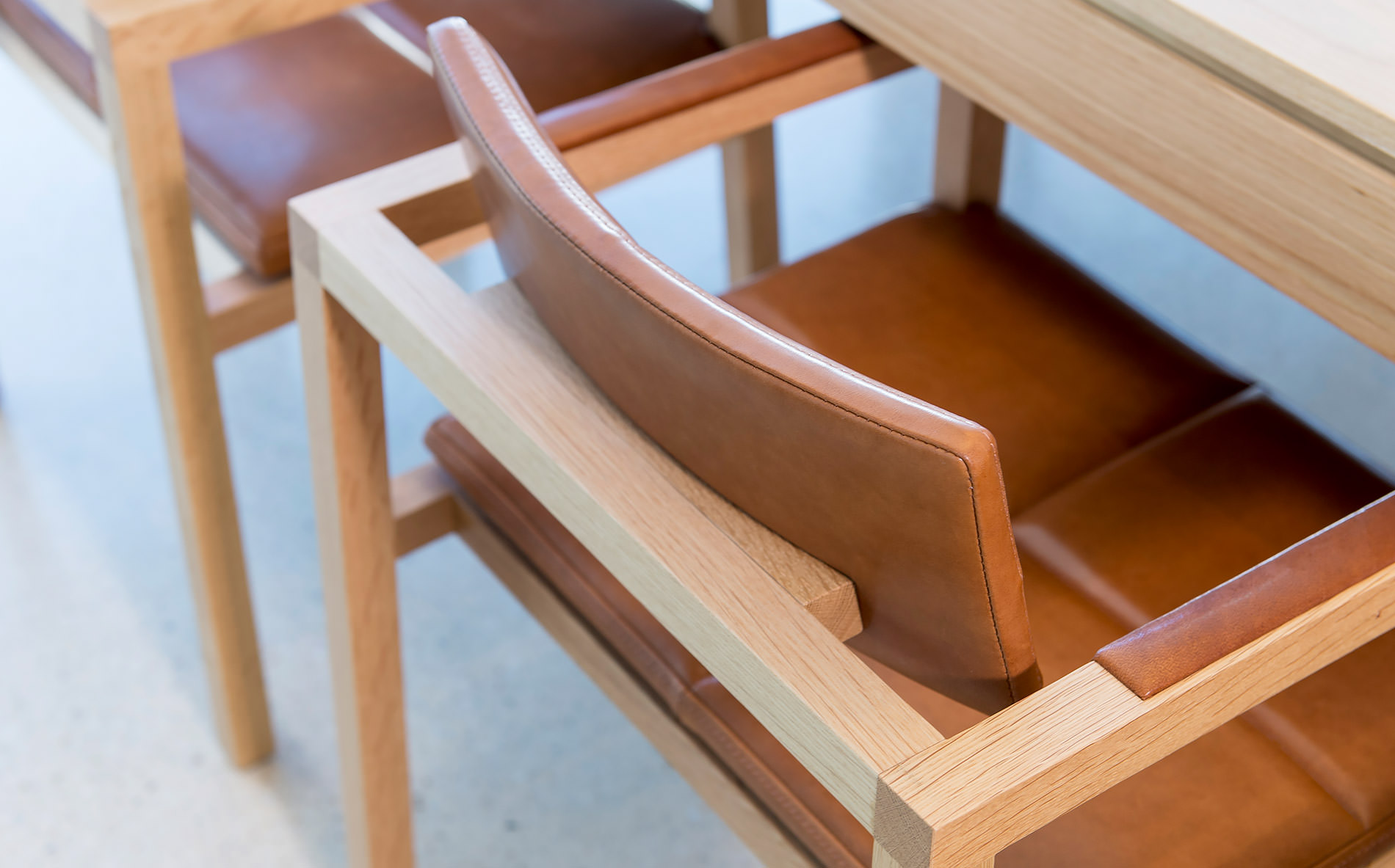 Soft and supple tan leather is a beautiful feature of these designer chairs by Australian designer FrancoCrea that surround the large designer dining table in this dining room