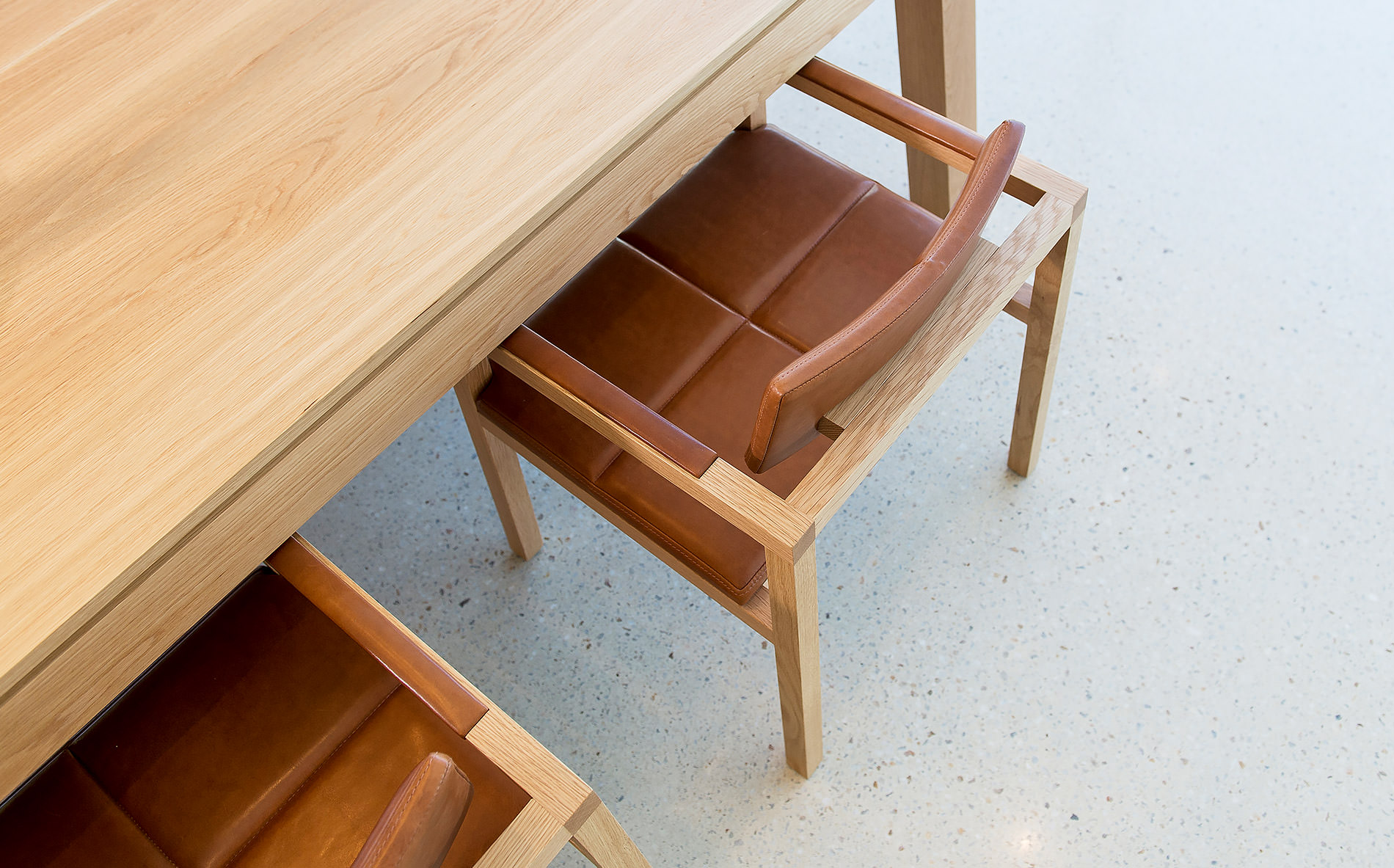 The minimalist family home is a pleasure to walk through on the concrete floors towards the designer dining table in solid oak by Australian designer francoCrea