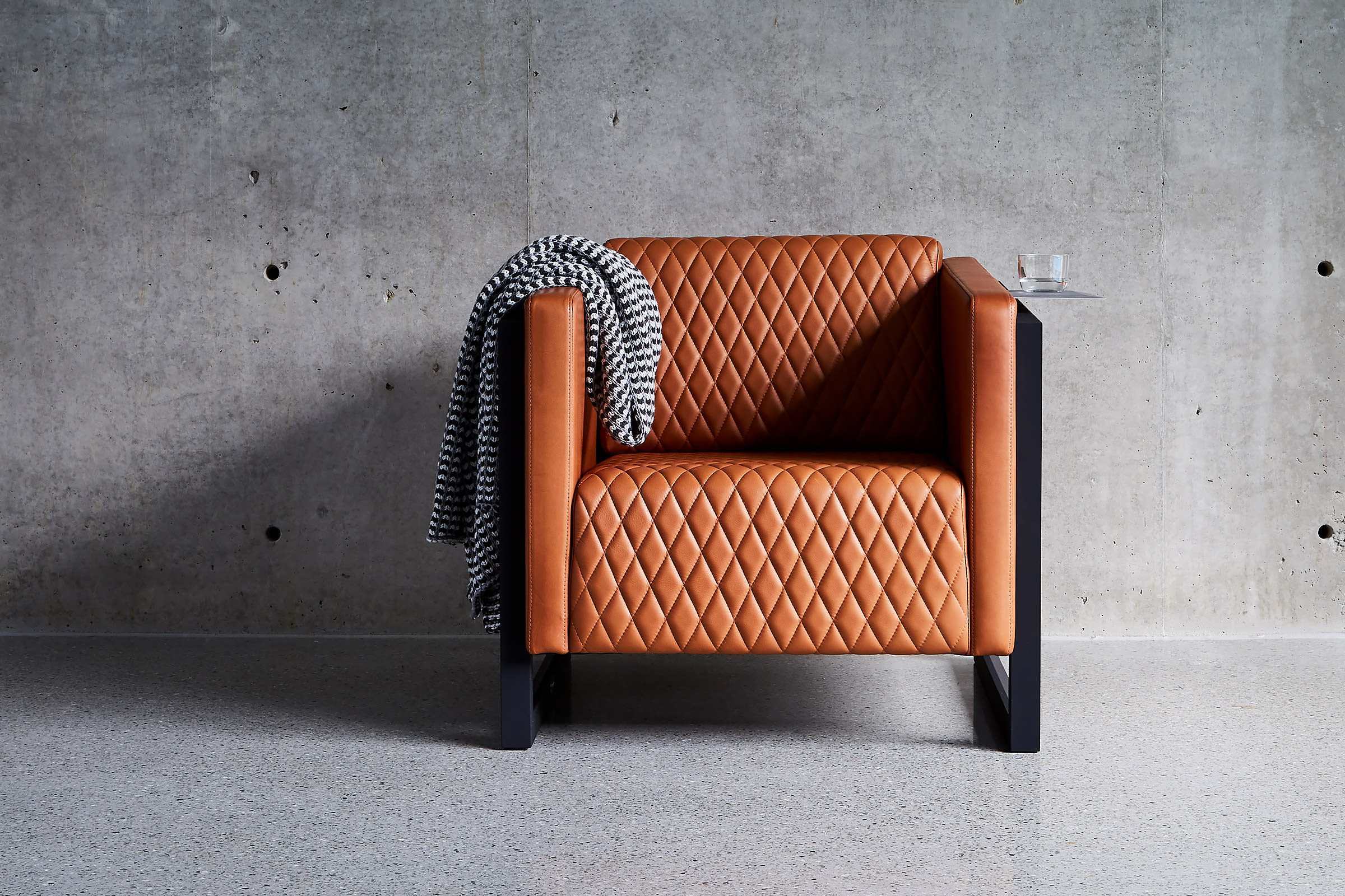 This minimalist Australian home is the perfect backdrop for the designer armchair by Australian designer FrancoCrea featuring soft supple tan leather