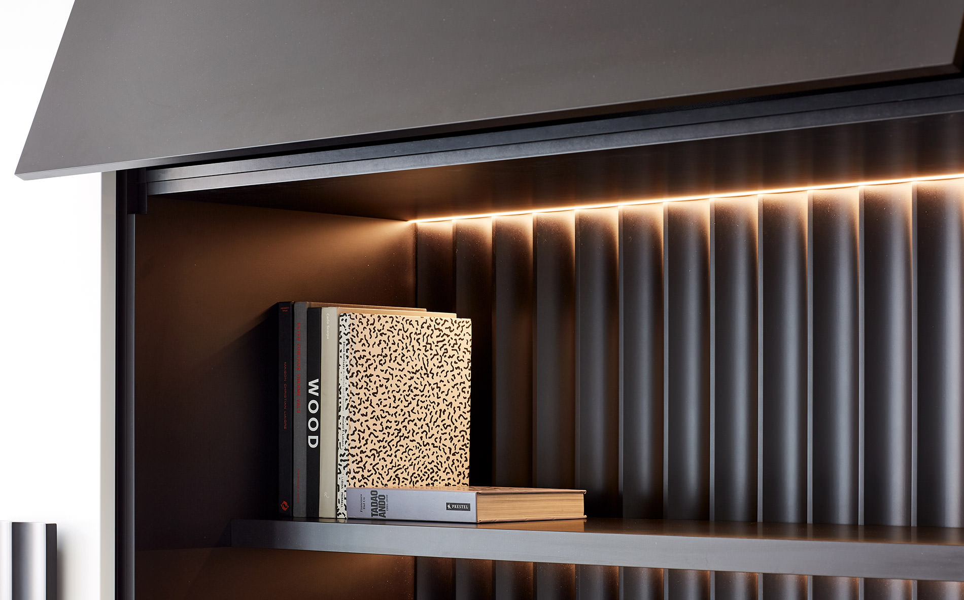 Purposefully perched on a stunning back lit shelf designed by Australian furniture designer FrancoCrea are two isolated books calling to be read