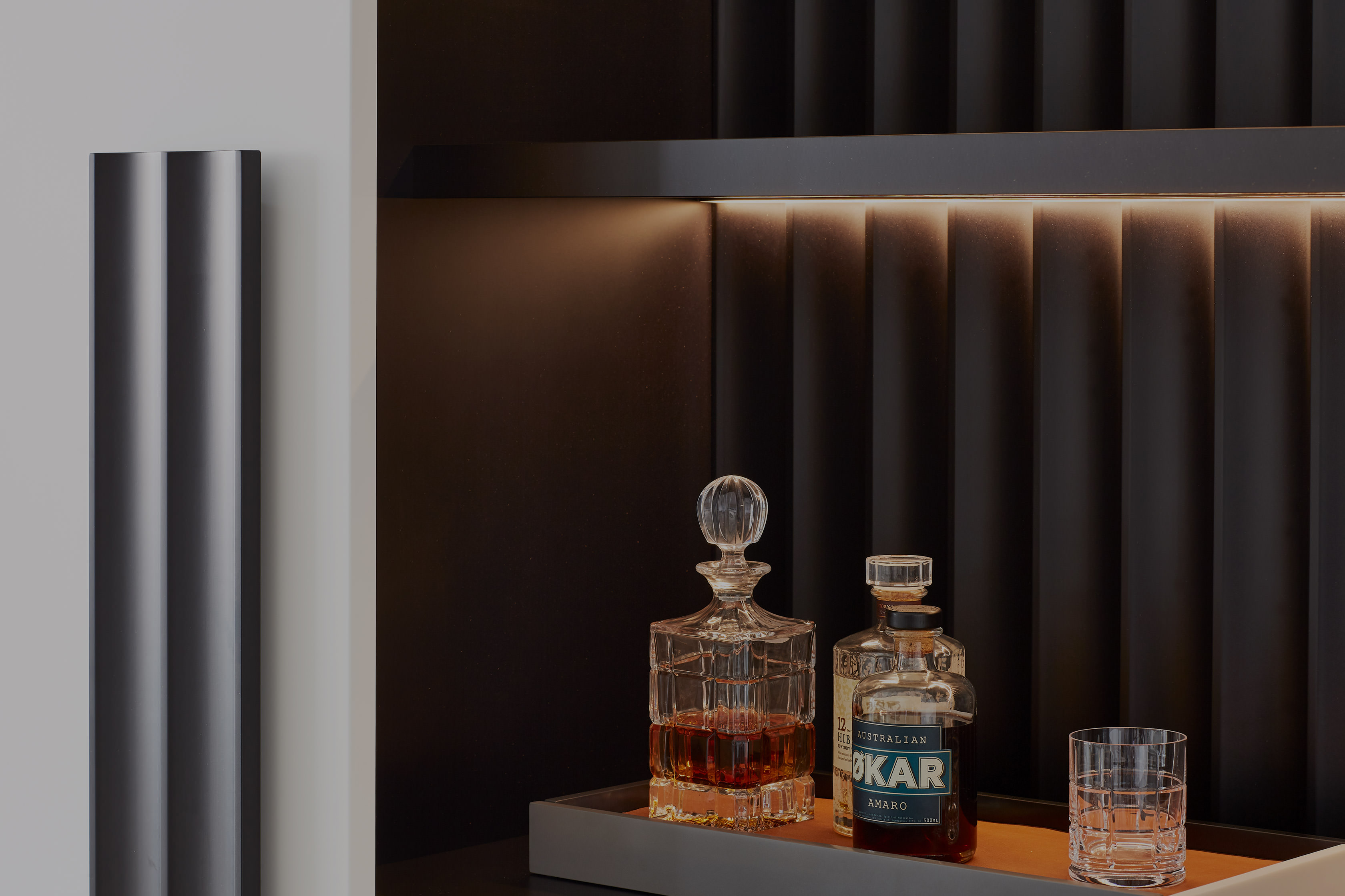 a hidden shelf reveals a treasure of cocktail mixers and ingredients to sooth a long day cleverly designed by Australian designer FrancoCrea