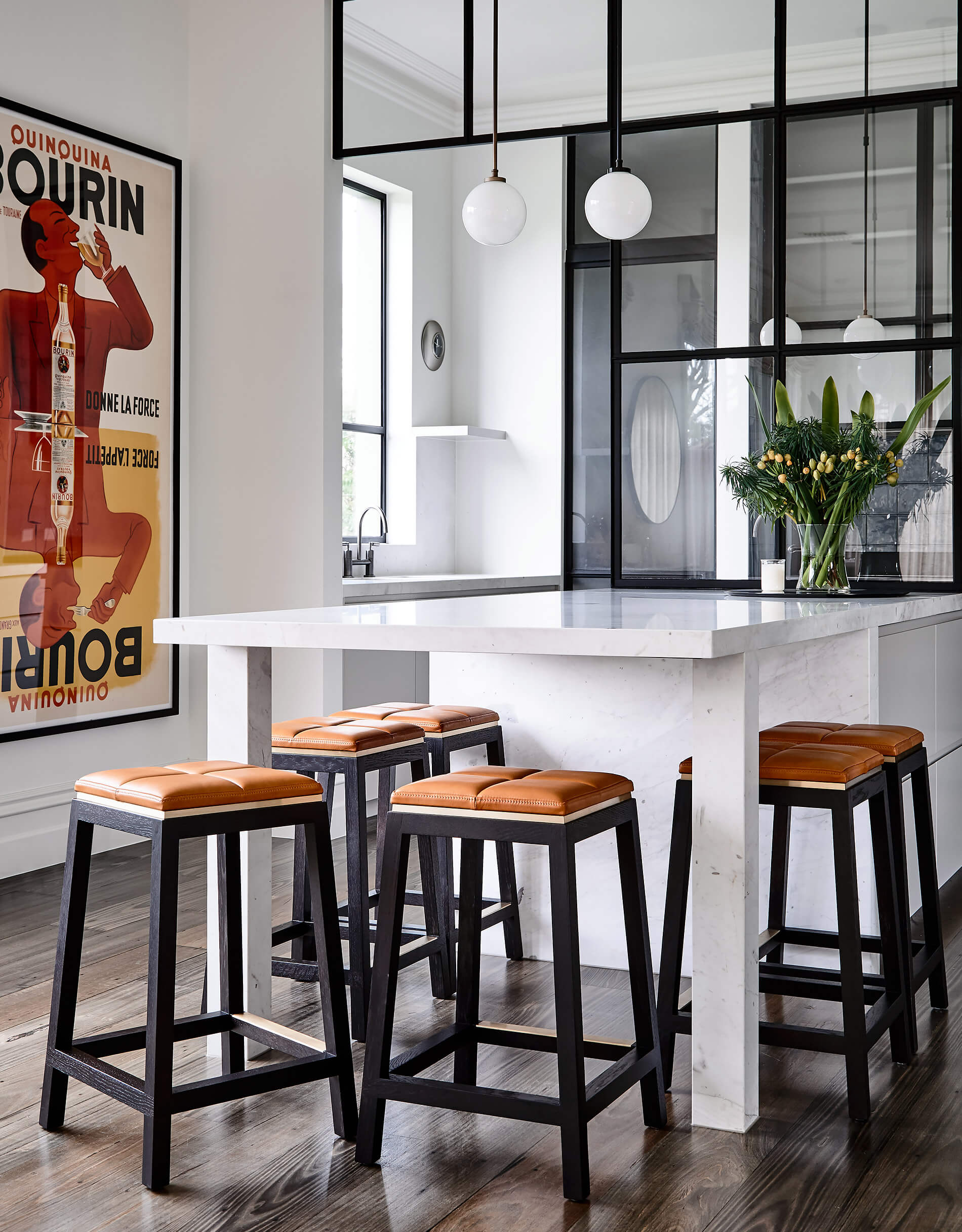 A beautifully contemporary family kitchen bench features here surrounded by Australian designer FrancoCrea's minimalist designer stools