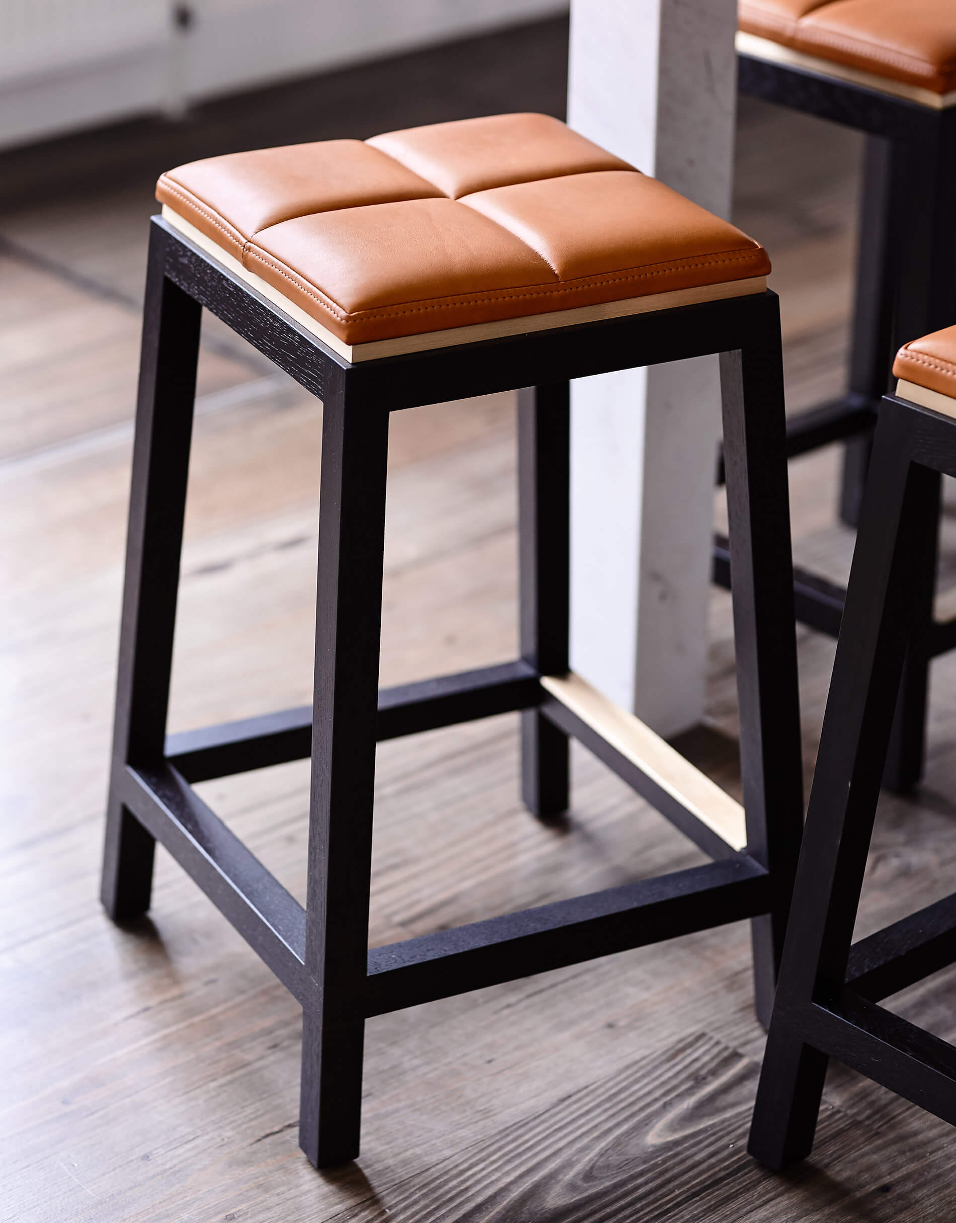 Light timber floors contrast the beautiful dark timber of the luxury designer stools by Australian designer FrancoCrea in this modern family home leave a sense of refined luxury as you walk through the space