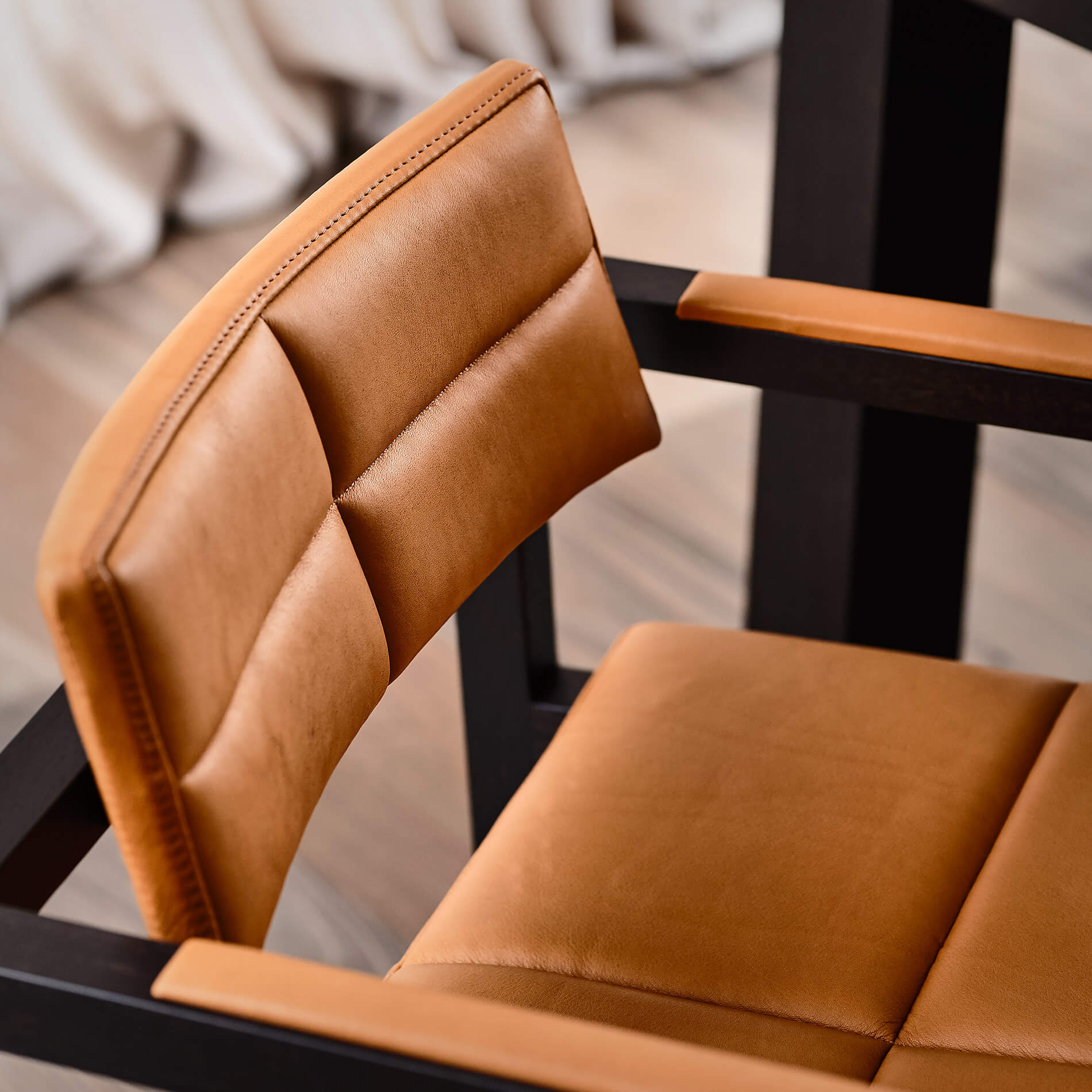 The dining room natural light shows stunningly the curves and comfort of these soft tan leather designer dining chairs by Australian designer francoCrea inviting you to sit and rest a while