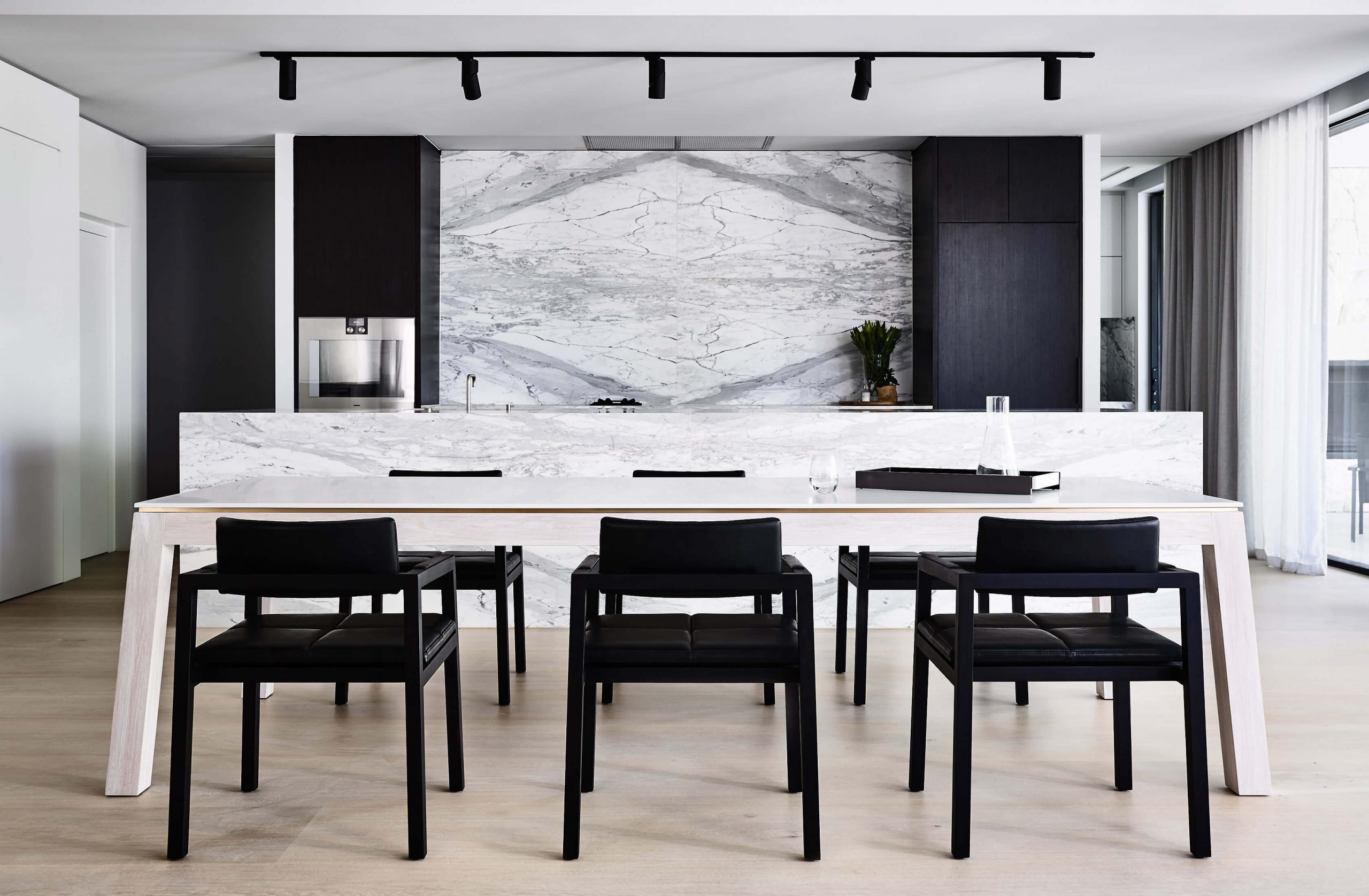 The beautiful marble back splash back in this dining setting is a hero feature not overpowered by the elegancy of the balance designer dining table set by Australian designer FrancoCrea