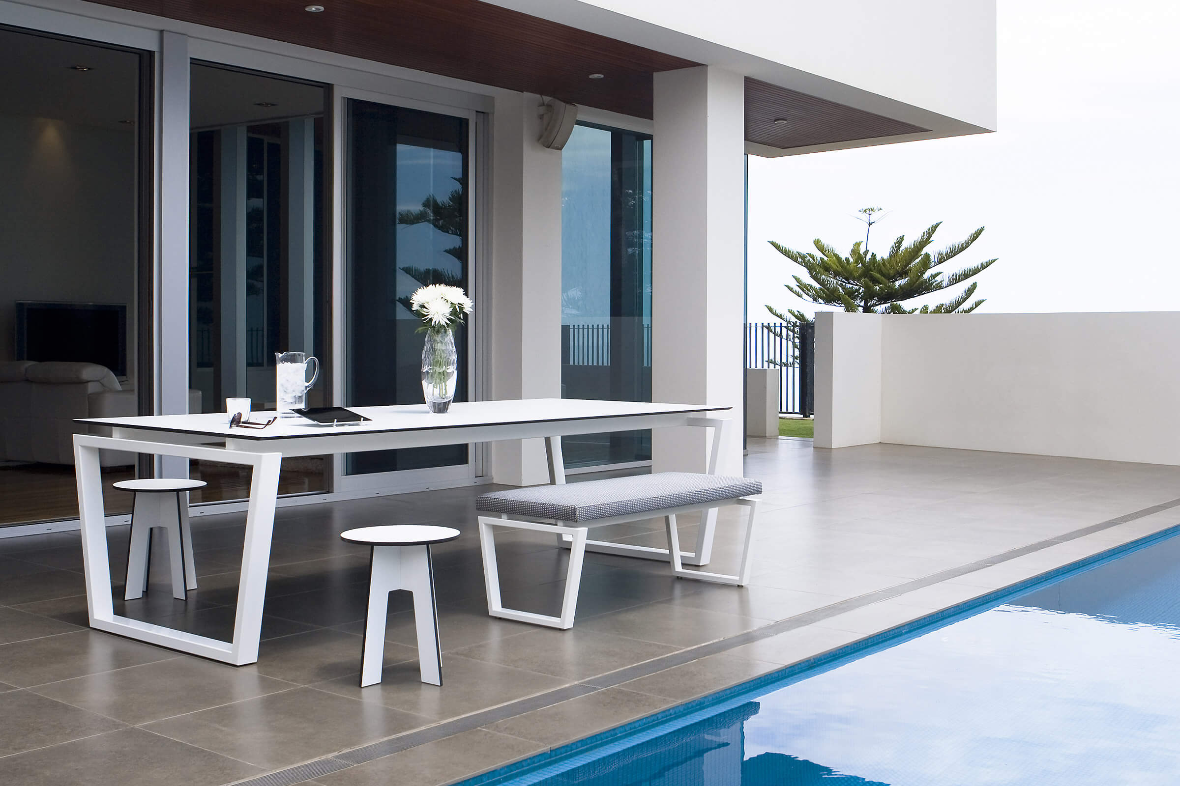 As you walk into this outdoor patio you gravitate immediately towards the designer outdoor table by Australian designer FrancoCrea to rest and chat a while in the warm summer air