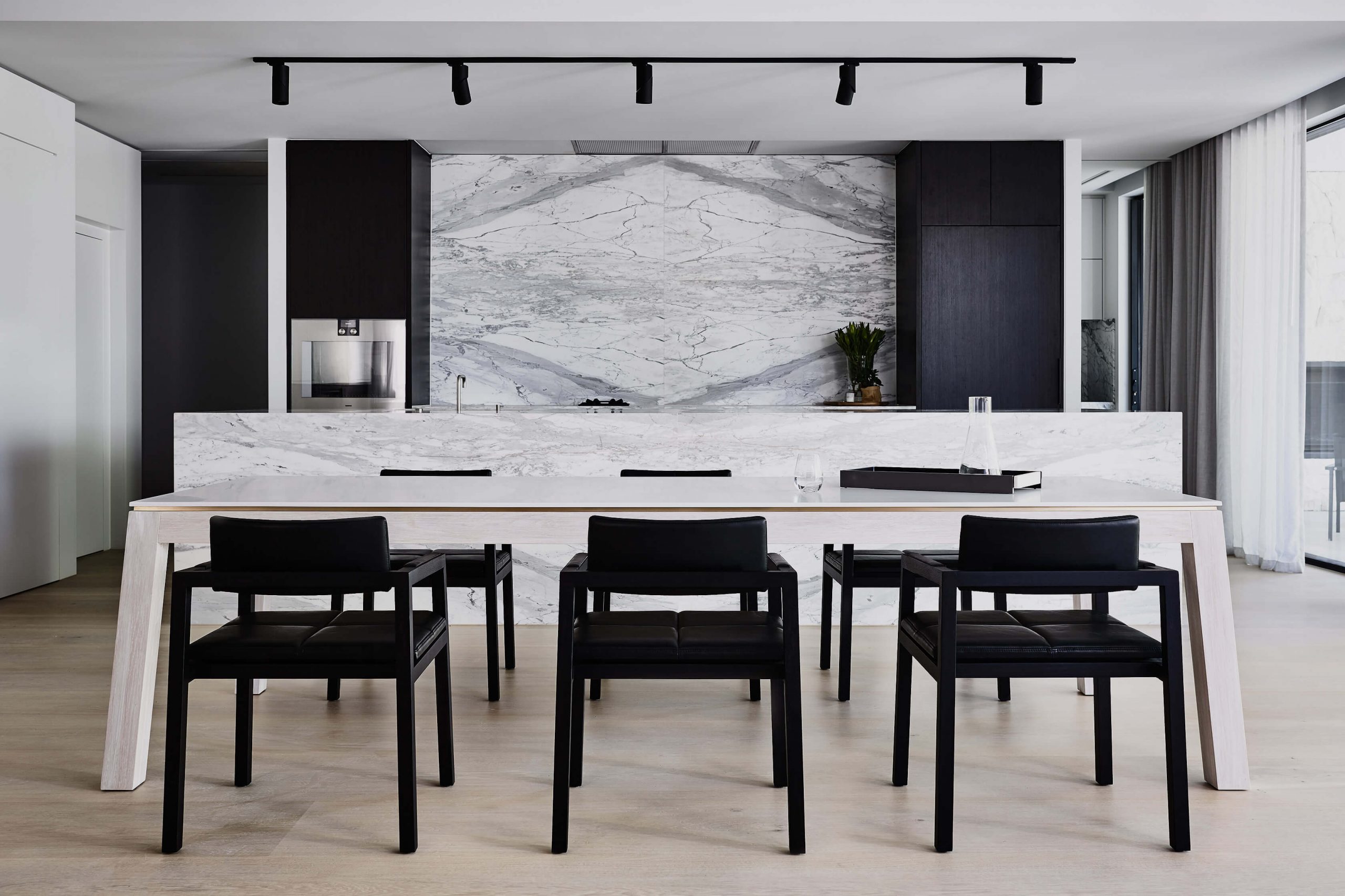 As you walk through this incredible architectural Australian home you immediately are drawn to sit and rest at the designer dining table by Australian designer FrancoCrea